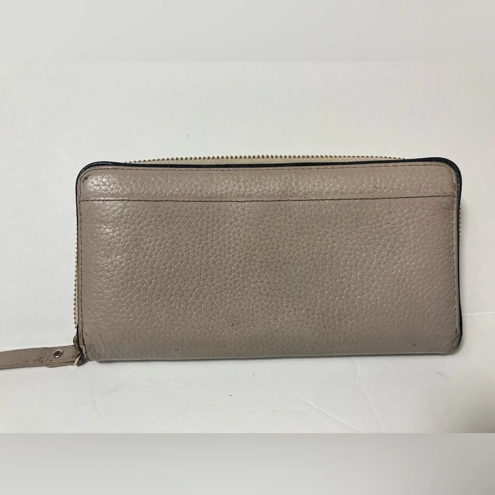 Kate Spade wallet pebble texture leather mauve color black trim tassel